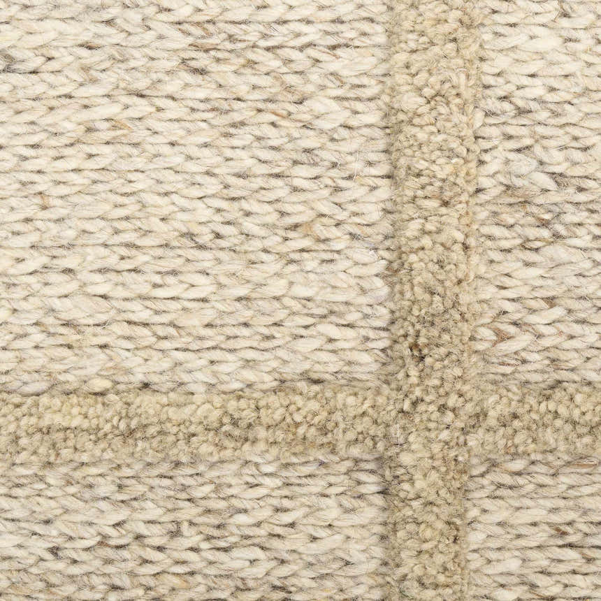 Close-up of the textured DKNY Pure Framework Camel rug. Handmade wool rug with a raised grid pattern.