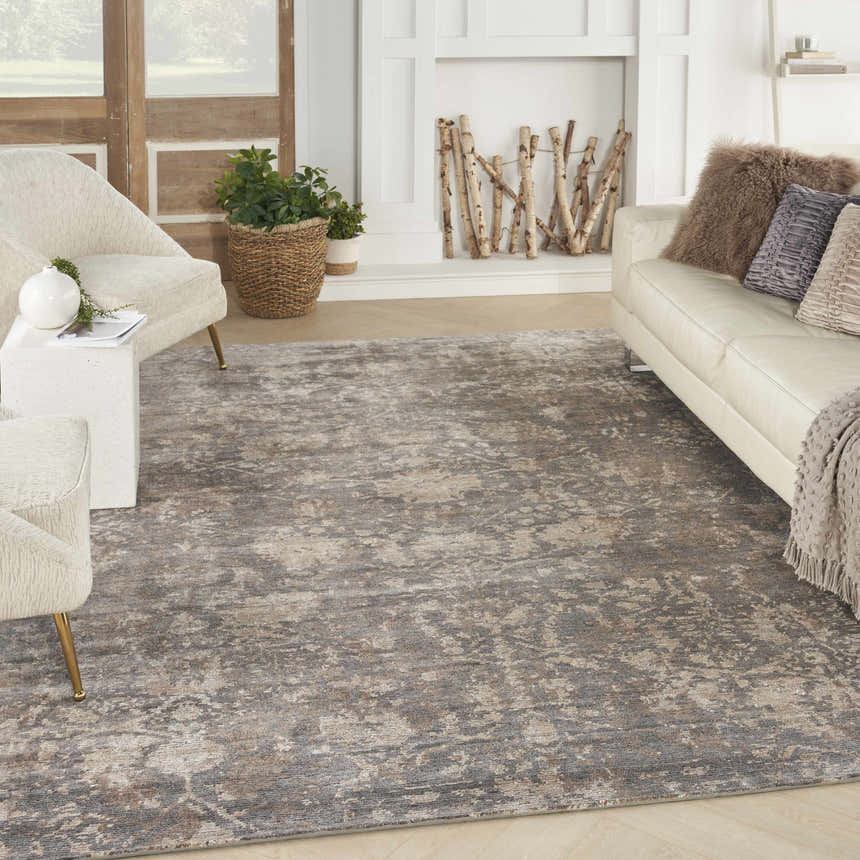 Living room scene with a Nourison Lucent Flint vintage rug, white sofa, and neutral armchairs.