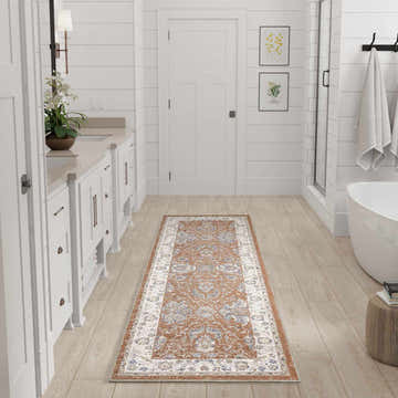 Bathroom scene with a Nourison Astra Rust Ivory Vintage runner rug on light wood floors.