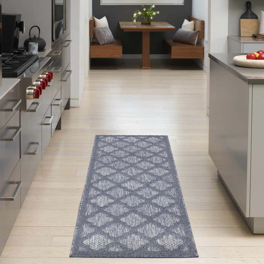 Modern kitchen with a Nourison Easy Care Denim Blue Area Rug runner.