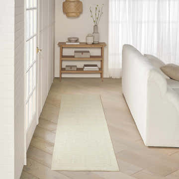 Entryway with white sofa and DKNY Pure Grids Ivory Beige rug runner on light wood floors. Contemporary style.