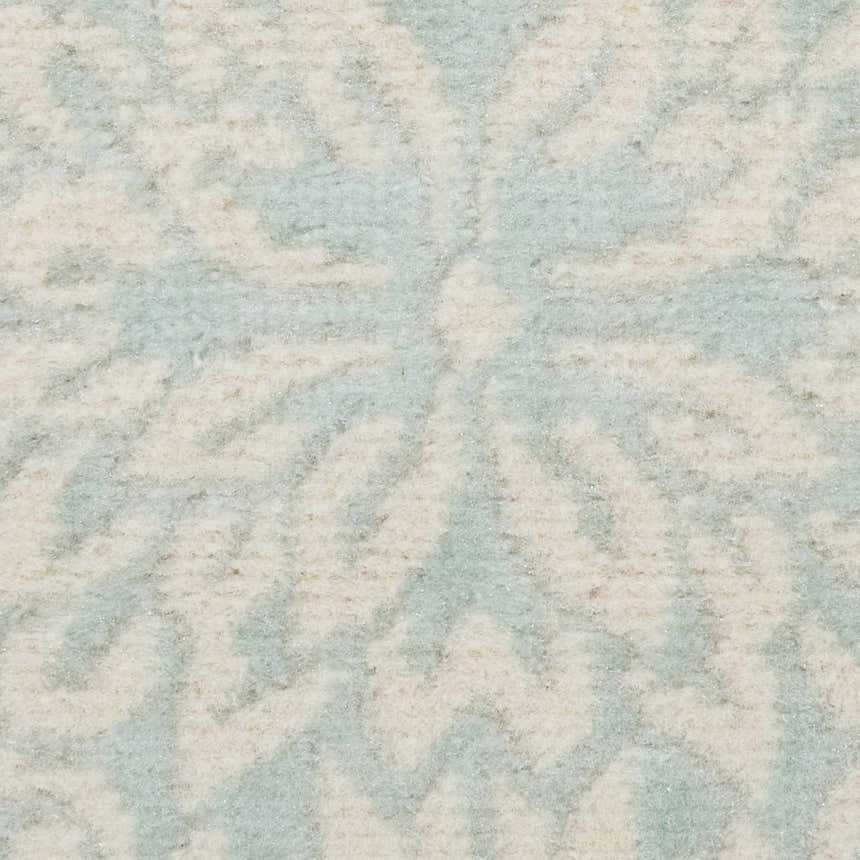 Close-up of the Nourison Jubilant Ivory Green rug showing its farmhouse-style pattern and soft, textured weave.