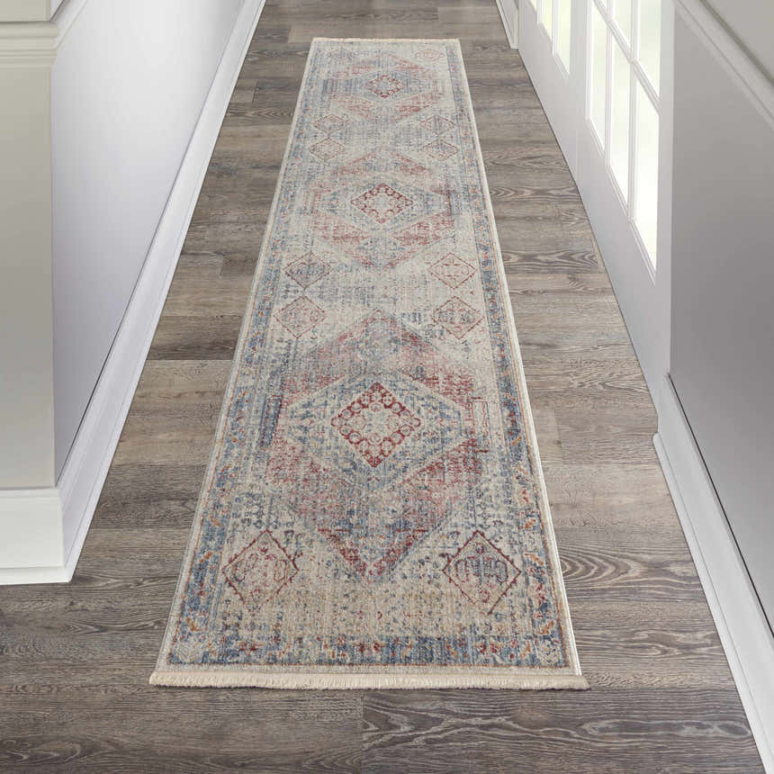 Hallway scene with Nourison Homestead Blue Grey Farmhouse runner rug on wood floor, white walls and door.