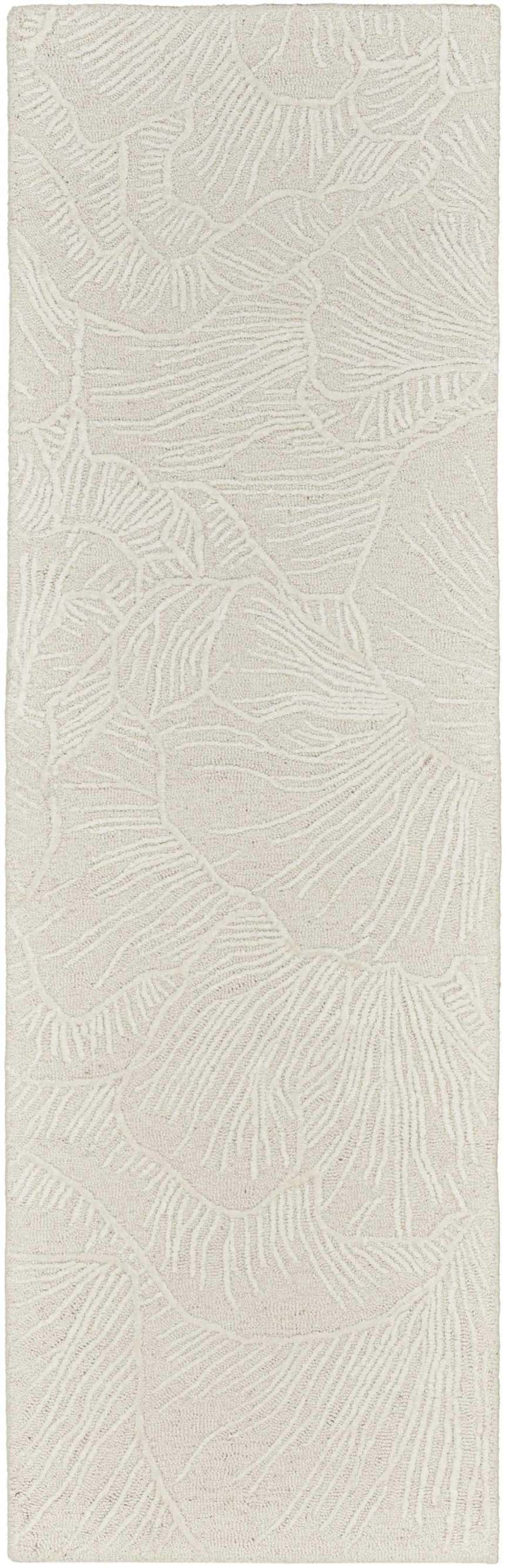 Close-up of the Nourison Avra Ivory rug. Creamy wool rug with a raised, abstract botanical design. Handmade texture.