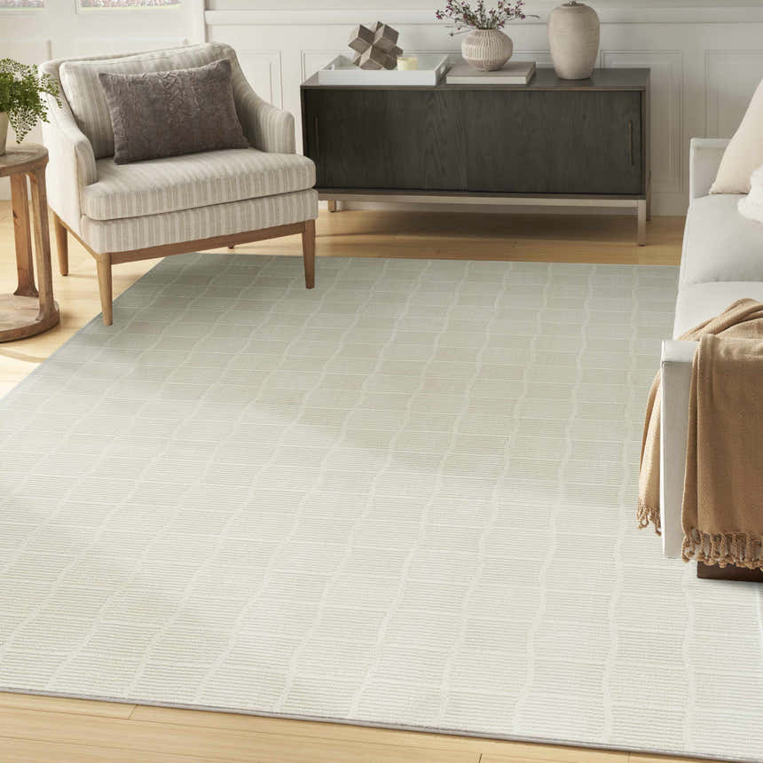 Living room scene with a Nourison Eco Cycle Ivory rug, modern furniture, and light wood floors.