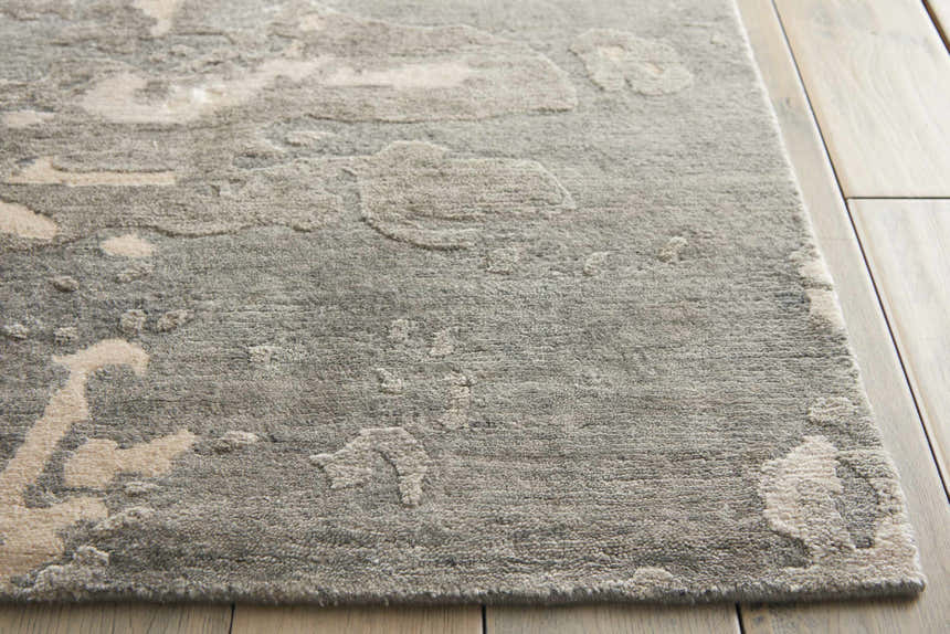 Close-up of the textured Nourison Silk Shadows Sand area rug with a subtle sandstone pattern on light wood floors.