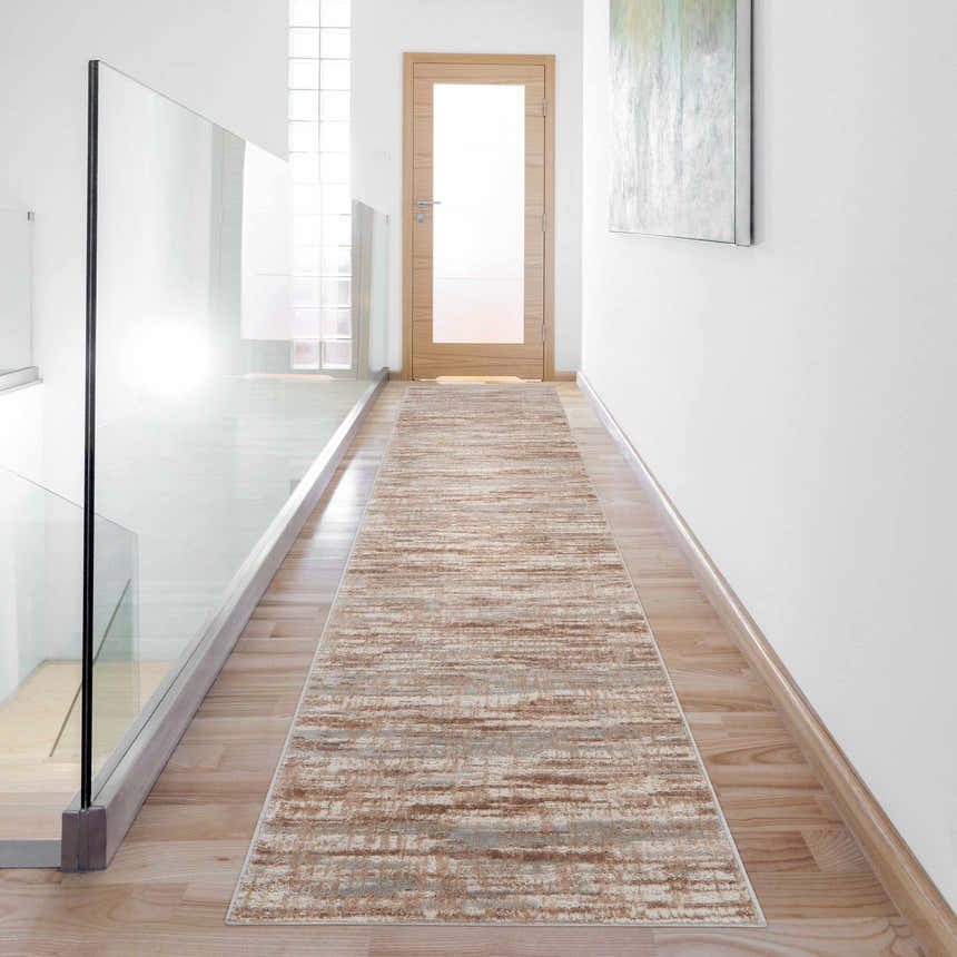 Bright hallway with Nourison Elation Ivory Grey runner rug, light wood floors, glass railing, and white walls.