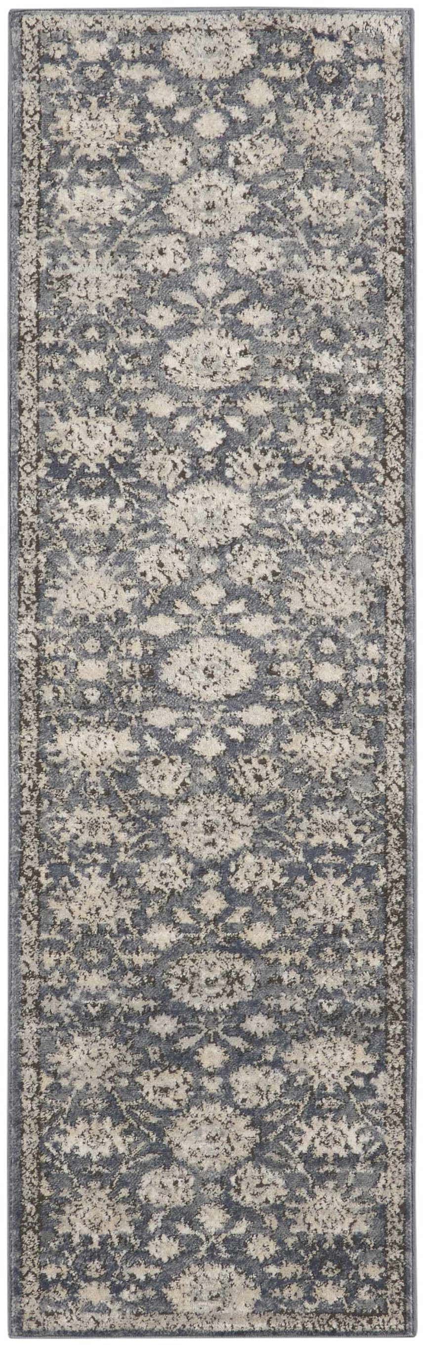 Close-up of Nourison Quarry Blue Beige Vintage Area Rug. Features distressed floral pattern in blue and beige tones.