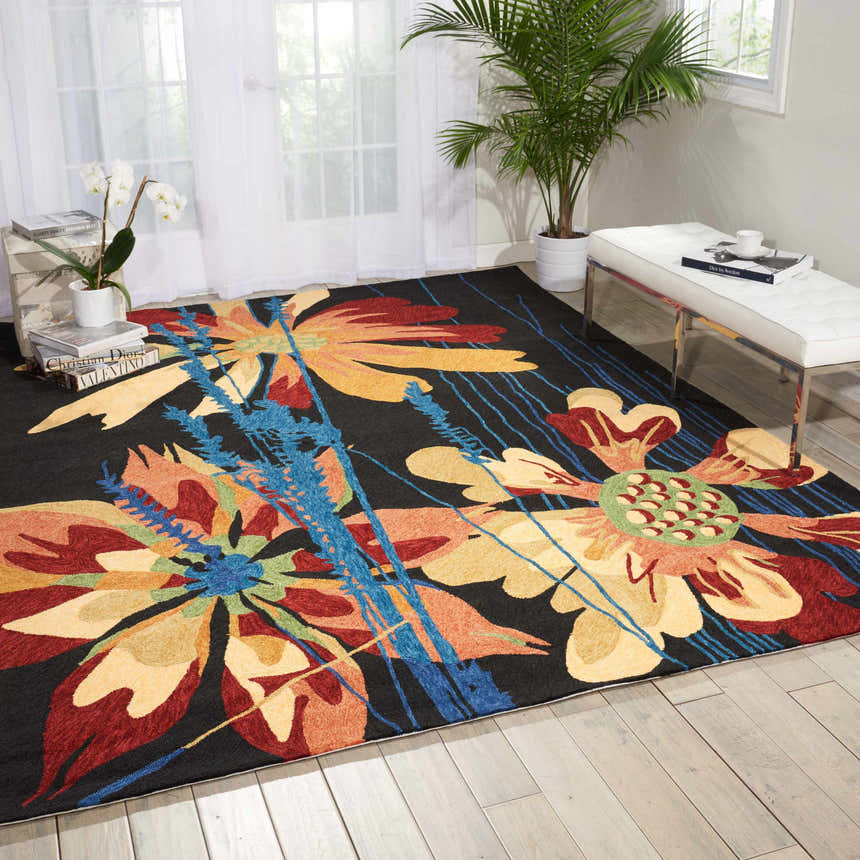 Bright living room with Nourison South Beach Black Area Rug featuring large floral pattern in red, yellow, and blue.