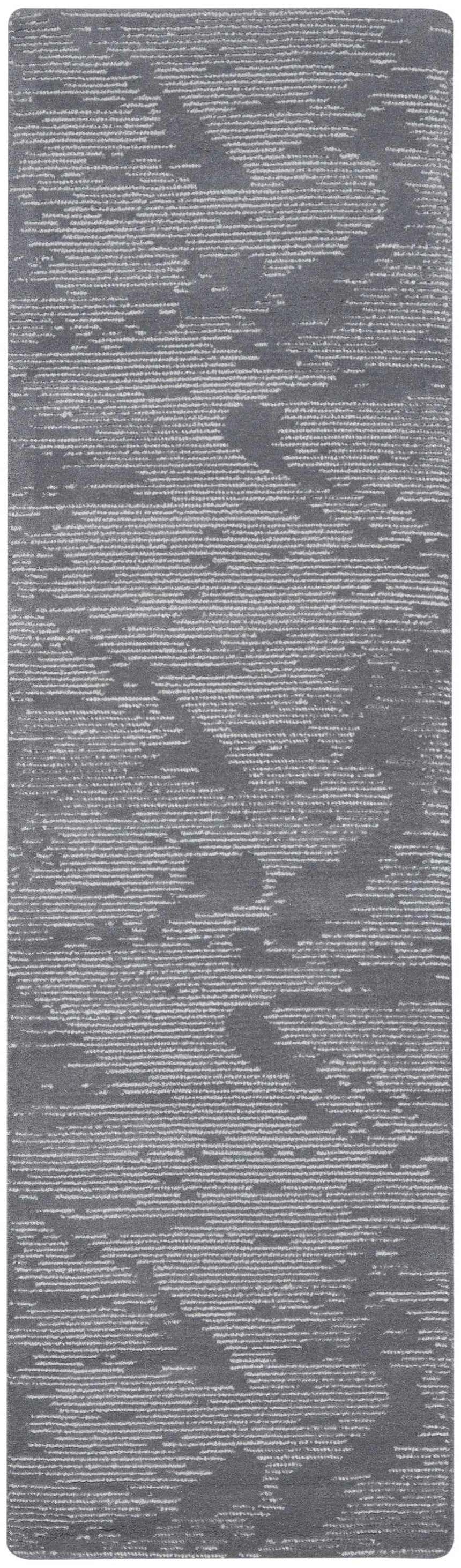 Close-up of the Michael Amini MA30 Star Blue rug. Light blue wool rug with a modern, abstract pattern and subtle texture.