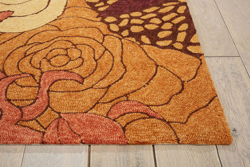 Close up of the handmade Nourison South Beach Spice Area Rug, featuring a floral design in spice tones and brown accents.