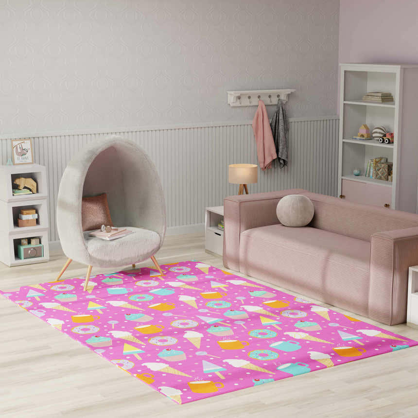 Kids room with pink sofa, egg chair, and Nourison Imagination Pink Multicolor rug featuring a fun dessert pattern.