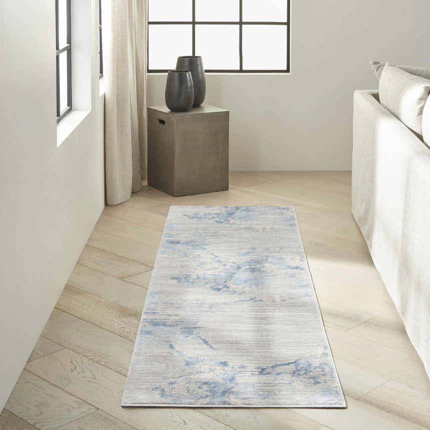 Minimalist living room with Calvin Klein CK005 Enchanting Grey Sky runner rug, light wood floors, and neutral decor.