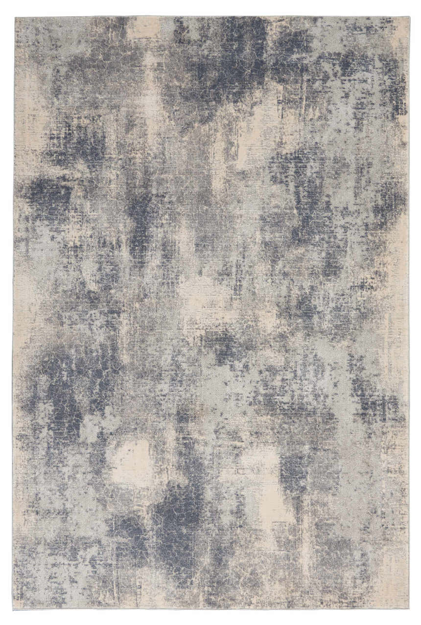 Close-up of the Nourison Rustic Textures Blue Ivory Area Rug, showing its distressed, mid-century modern design and soft texture.