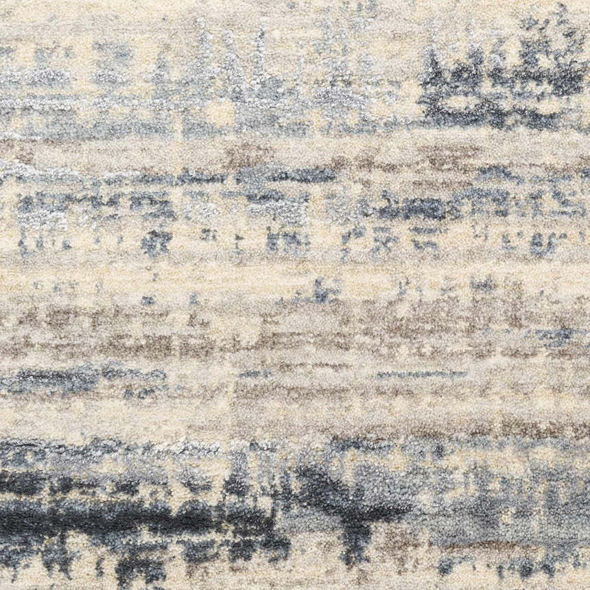 Close-up of the Calvin Klein CK089 Drift Blue rug. Features a textured, abstract pattern in light blue, gray, and cream hues.