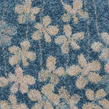 Close-up of the Nourison Tranquil Turquoise rug. Aqua background with beige and pink floral pattern. Contemporary style.