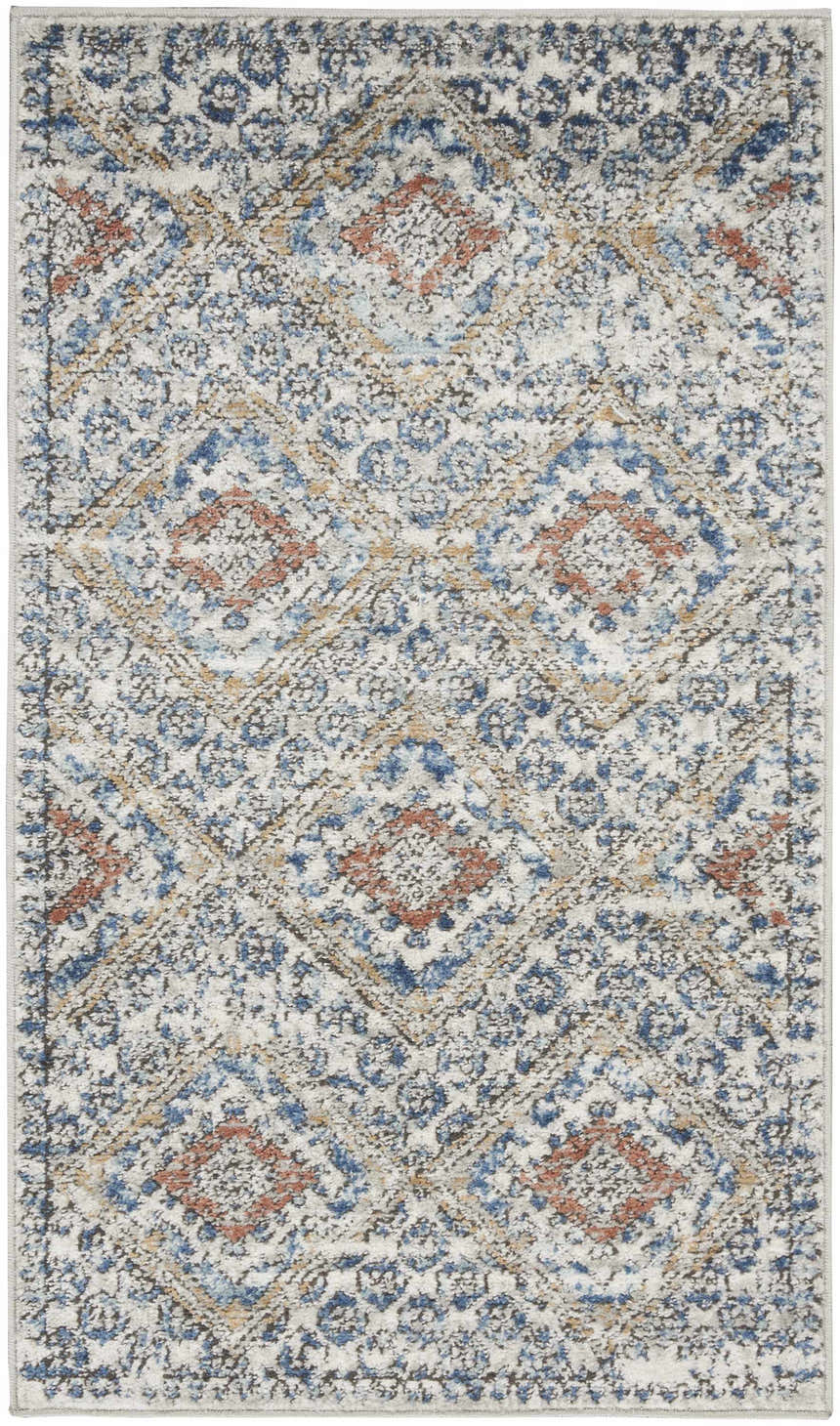Close-up of the Nourison Quarry Blue Ivory Southwestern rug, featuring a chestnut, blue, and ivory diamond pattern.