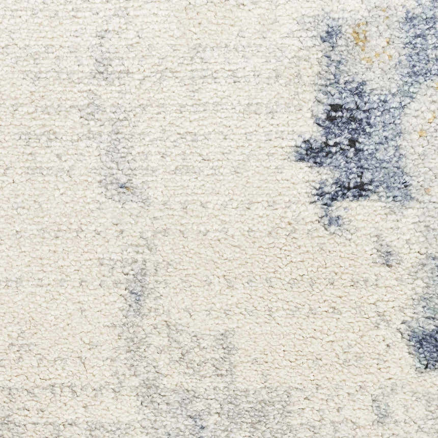 Close-up of the Nourison Motion Ivory Blue rug, showing a low pile texture and modern abstract pattern.