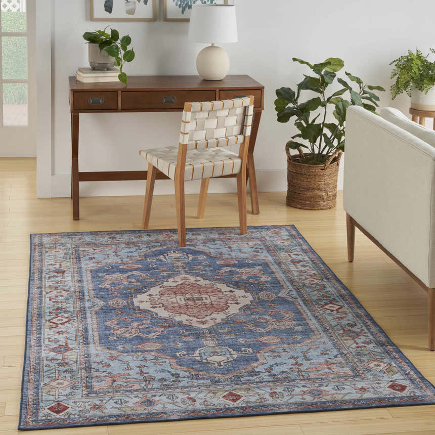 Light blue Nourison Fulton vintage rug in a home office with desk, chair, and neutral sofa.
