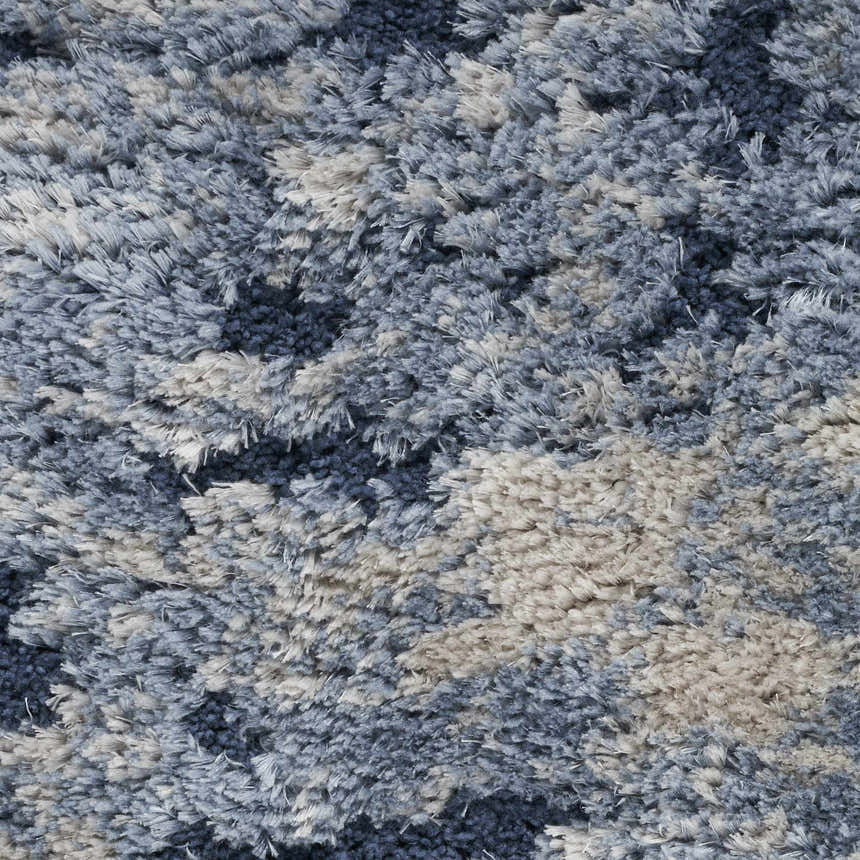 Close-up of the plush texture and light blue tones of the Nourison Dreamy Shag area rug.