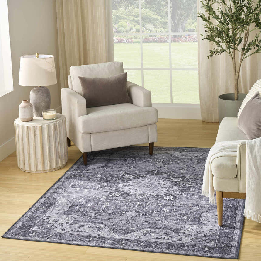 Living room scene with a Nourison Charcoal Grey Vintage Indoor Washable Area Rug, neutral furniture, and natural light.