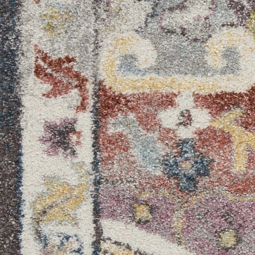 Close-up of Nourison Soraya Charcoal Multi rug. Colorful floral pattern in taupe, red, purple, and yellow hues. Soft texture.