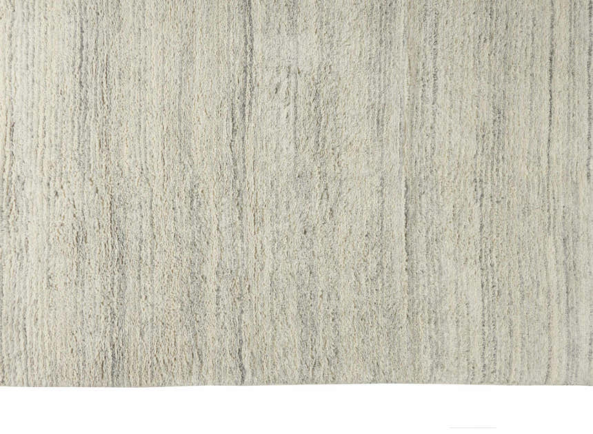 Close-up of the Calvin Klein Agadir Silver Shag Rug. The handmade wool rug has a soft texture and subtle silver gray stripes.