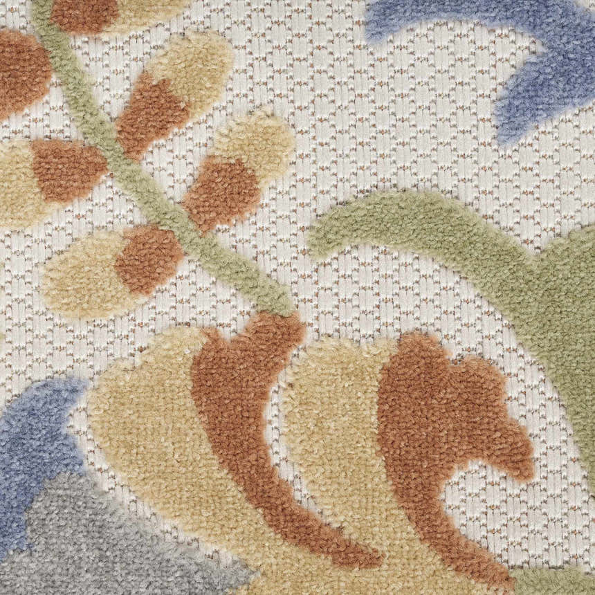 Close-up of the Nourison Aloha Ivory Blue Outdoor Area Rug, showcasing floral pattern and textured weave.