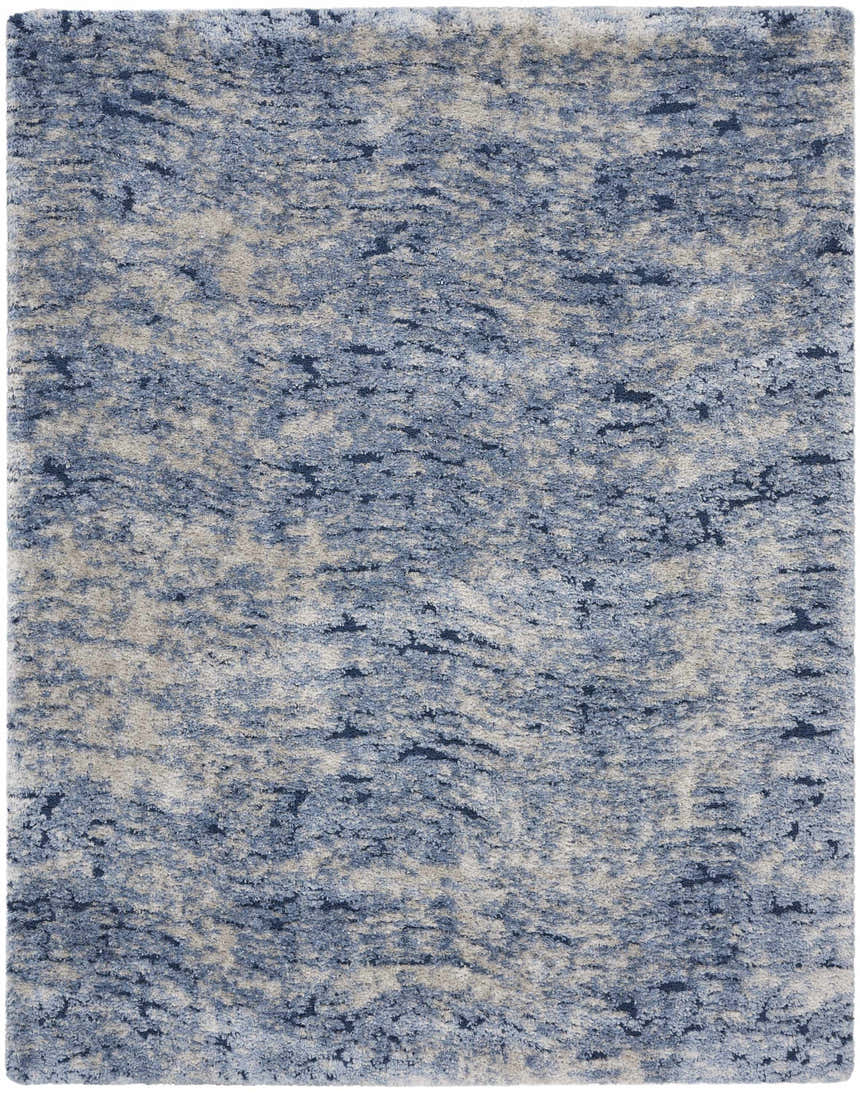 Close-up of a Nourison Dreamy Shag Light Blue rug. Shag texture with light blue, dark blue, and beige abstract pattern.