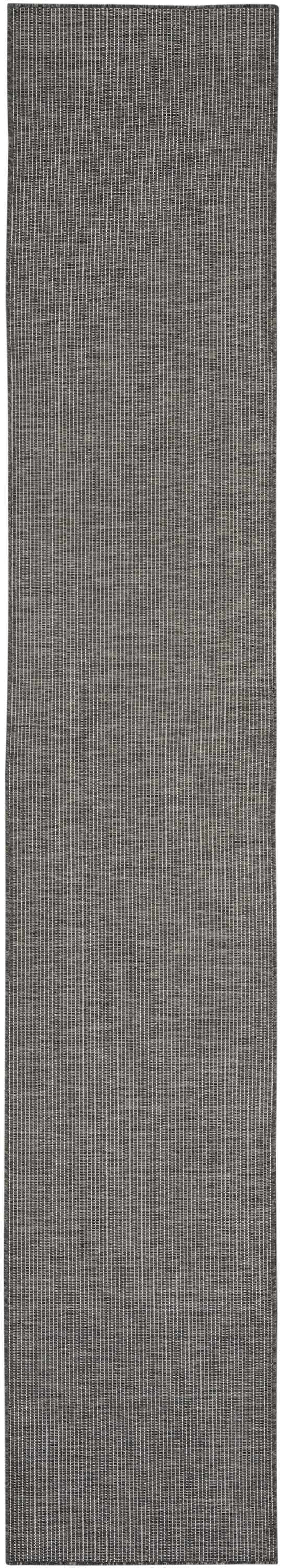 Close-up of the Nourison Positano Charcoal rug. Modern design with taupe vertical lines and a woven texture.