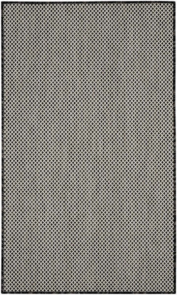 Close-up of the Nourison Courtyard Black White Modern Area Rug featuring a diamond pattern and woven texture.