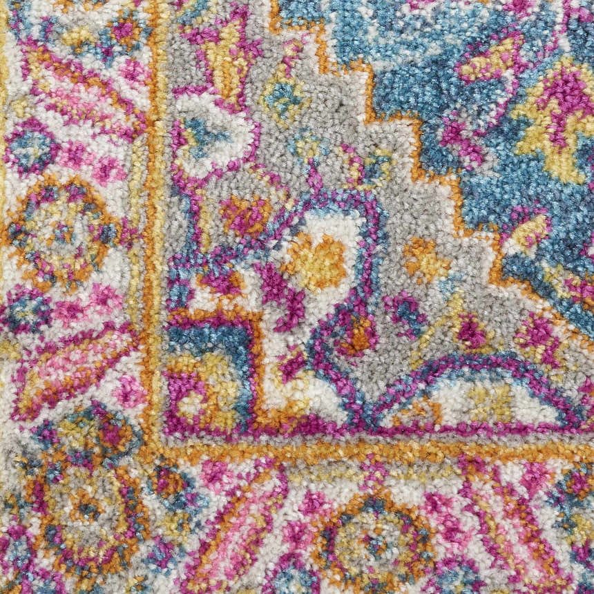 Close-up of the Nourison Passion Teal Multicolor rug showing its bohemian pattern, teal, pink, and gold colors.