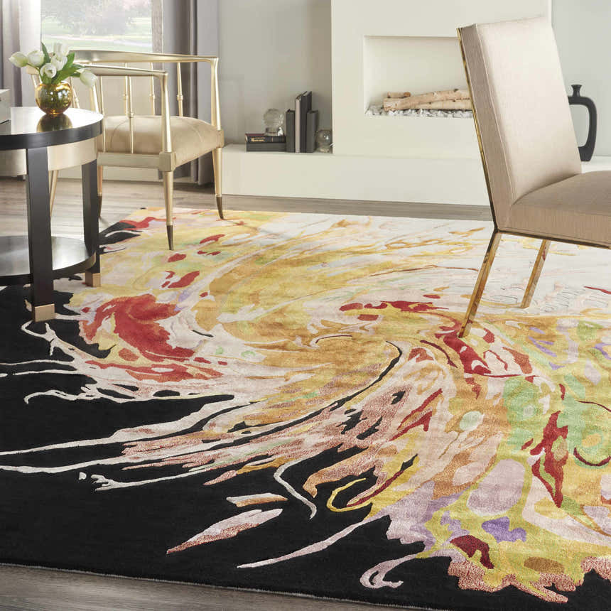 Modern dining room with Nourison Prismatic Multicolor rug, gold chairs, round table, and fireplace.