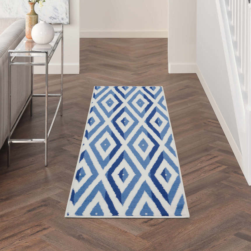 Hallway with Nourison Whimsicle Ivory Blue rug runner. Modern diamond pattern in blue hues on a chestnut wood floor.