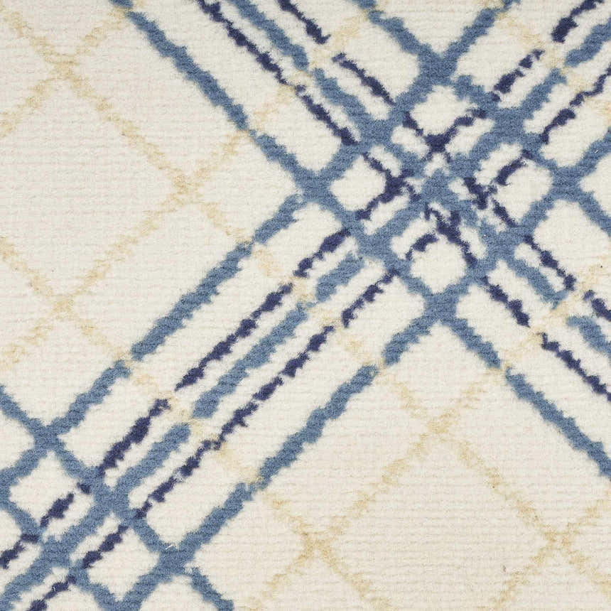 Close-up of Nourison Jubilant Ivory Navy rug. Farmhouse style with blue and tan plaid pattern on a soft, textured ivory background.