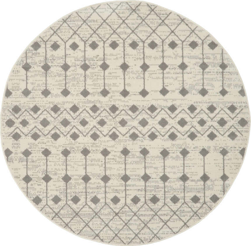 Close-up of a round Nourison Grafix Ivory/Grey rug. Features a geometric diamond pattern in gray on an ivory background.