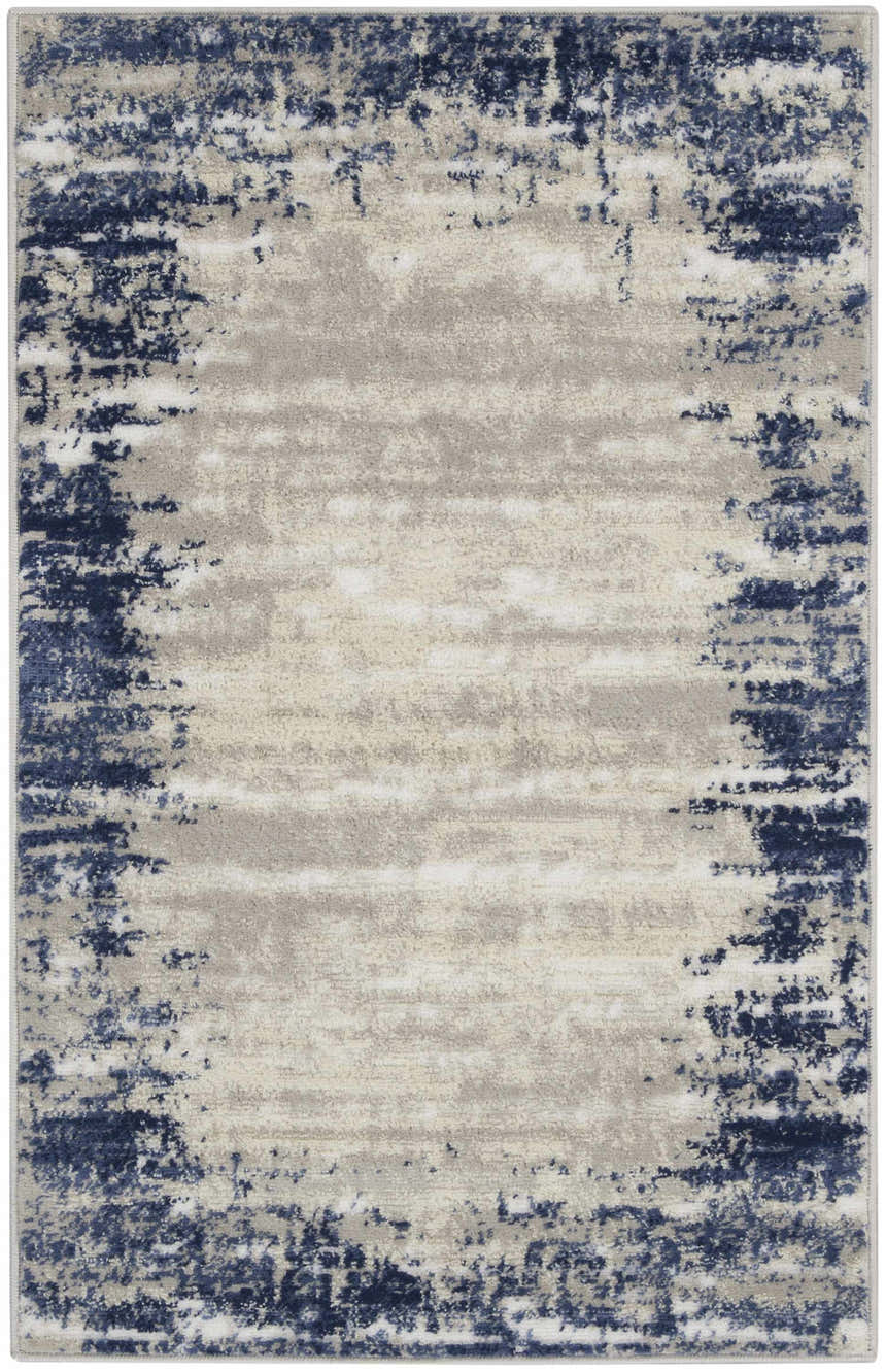Close-up of the Nourison Cyrus Ivory Navy rug, featuring a distressed abstract border design in navy and chestnut.