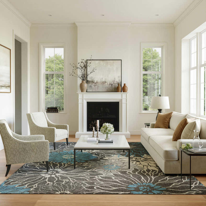 Living room scene with a Nourison Passion Charcoal Blue rug, white sofa, fireplace, and two armchairs.
