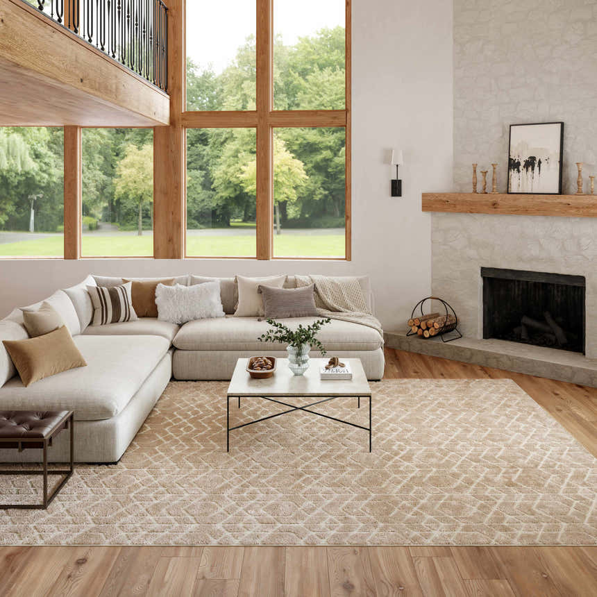 Light-filled living room with a beige sectional and Nourison Charm Beige Ivory rug with a geometric pattern.