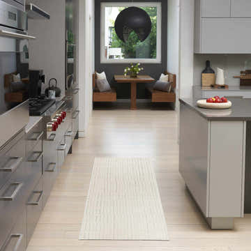 Modern kitchen with stainless steel appliances and Nourison Ivory Grey Scandinavian runner rug.