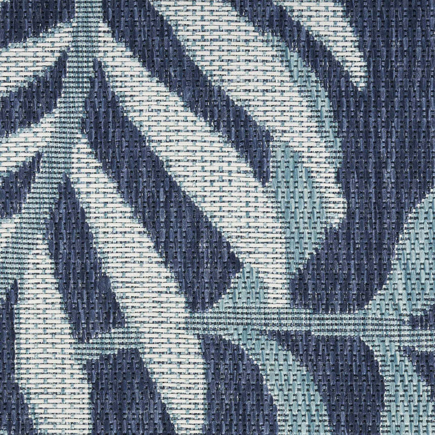 Close-up of the navy Nourison Garden Oasis rug showing a woven tropical leaf pattern and texture.