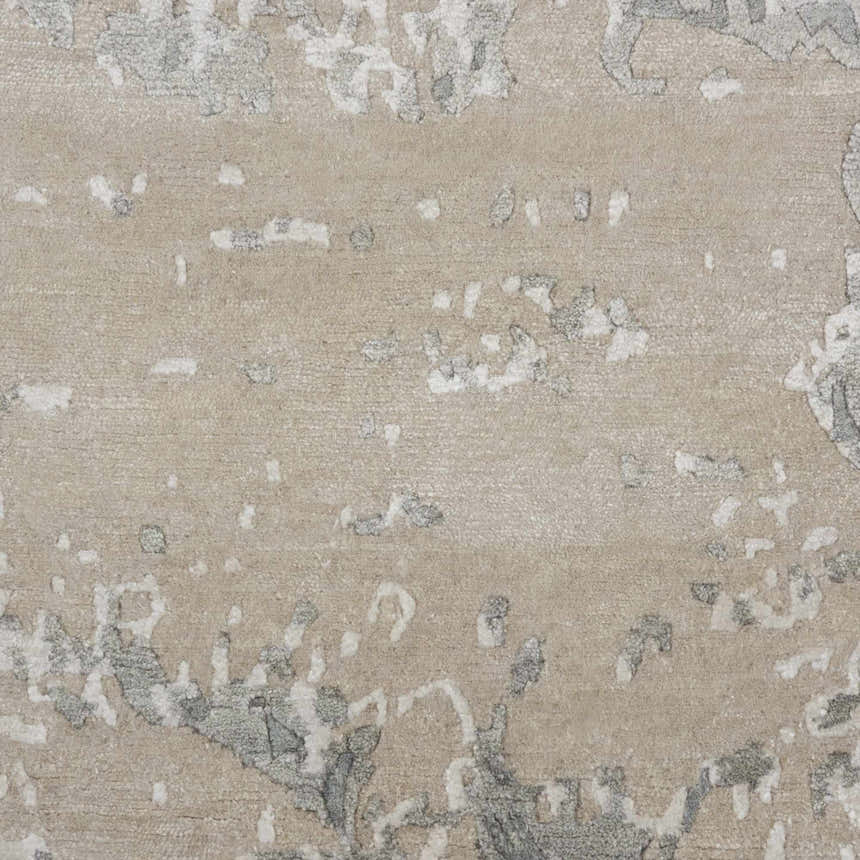 Close-up of the Nourison Silk Shadows Sand area rug. Shows sandstone color and abstract design with silk-like texture.