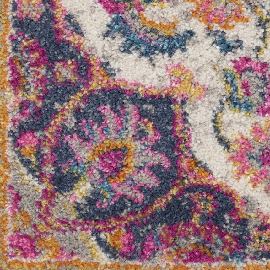 Close-up of Nourison Passion Ivory Multicolor rug showing texture and floral pattern in chestnut, pink, blue and gold tones.