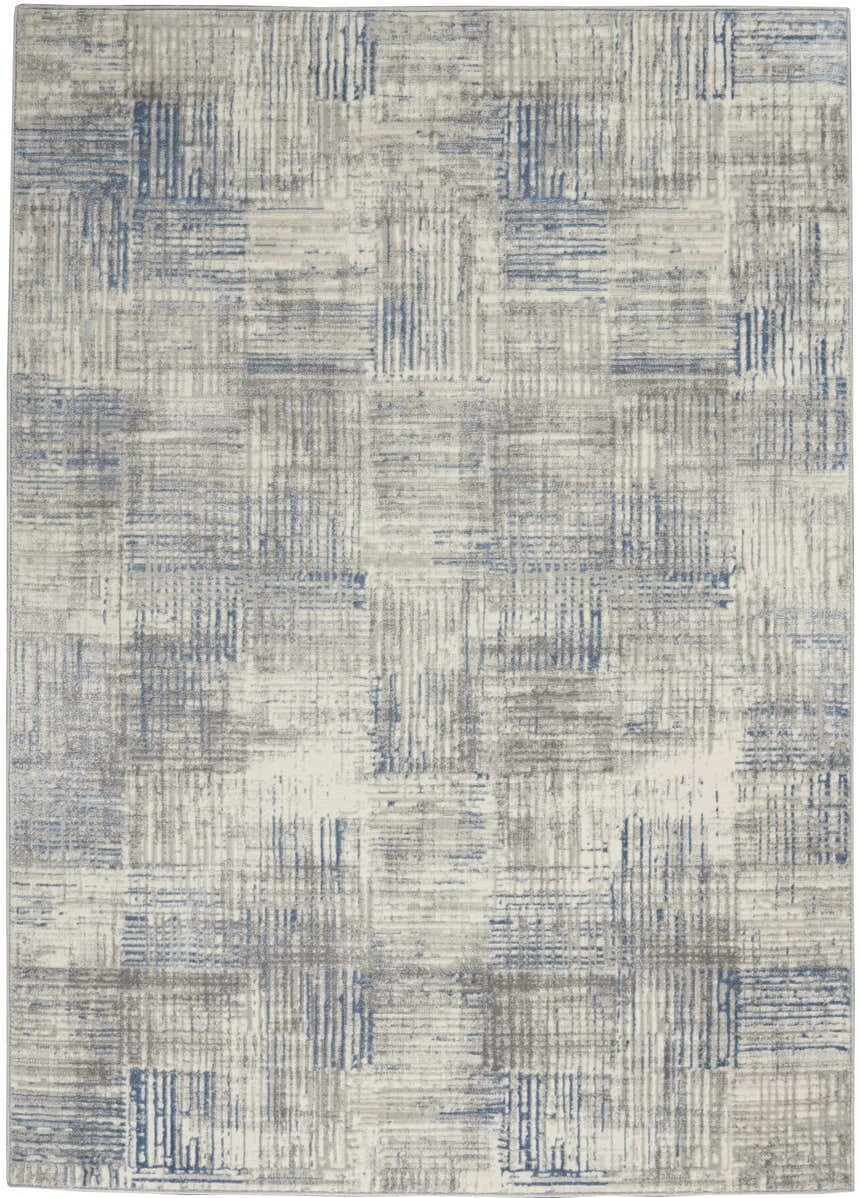 Close-up of Nourison Solace Ivory Grey Blue Rug. Modern high pile rug with blue and grey geometric pattern.