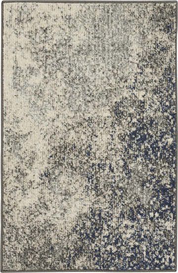 Close-up of the Nourison Passion Charcoal Ivory rug featuring a distressed taupe, ivory, and navy blue pattern.