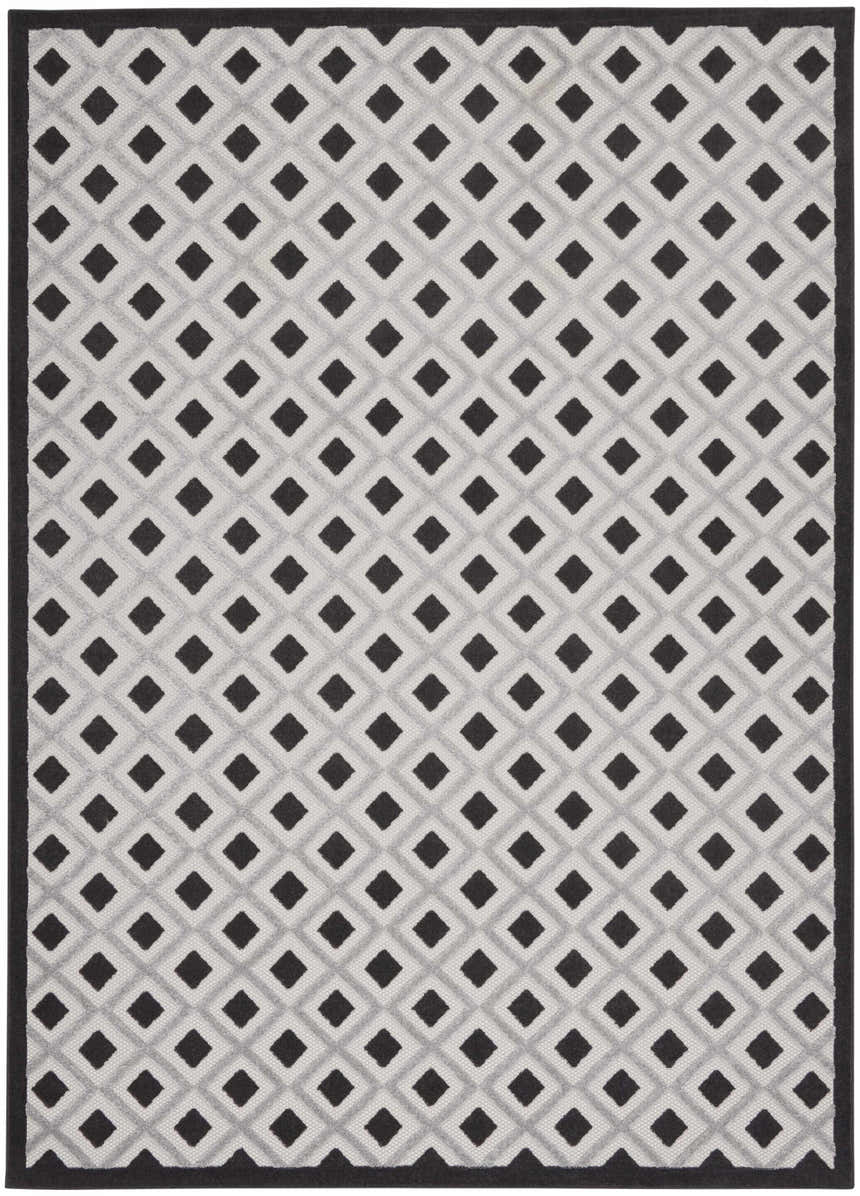 Close-up of Nourison Aloha Black White Modern Area Rug with geometric diamond pattern and black border.