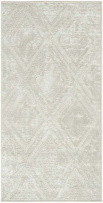 Close-up of the beige Nourison Dekor rug. High pile, machine-made with a subtle, geometric pattern.