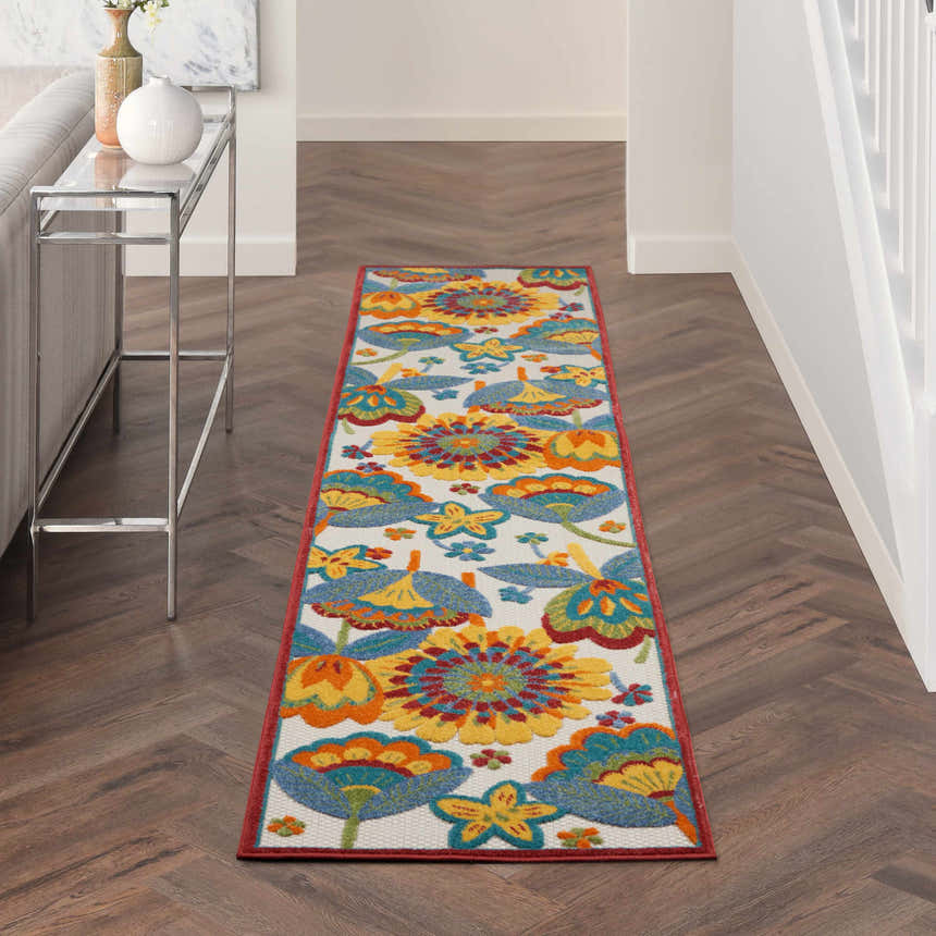 Hallway with Nourison Aloha Multicolor Contemporary Area Rug runner, floral pattern, wood floors, and console table.