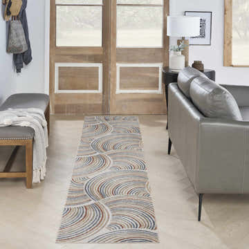 Entryway with gray bench, leather sofa, and Nourison Astra Ivory Multicolor rug runner.