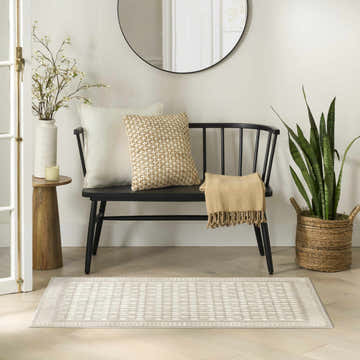 Entryway with black bench, round mirror, and Nourison Nordic Ivory Modern Area Rug runner.